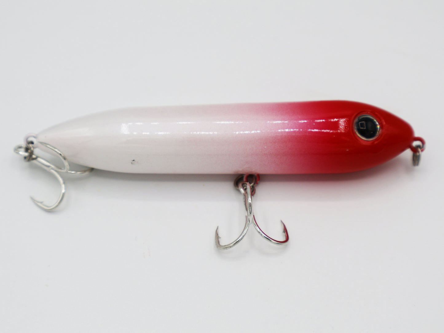 TAQL Skipper topwater lure in the classic red and white color combination.